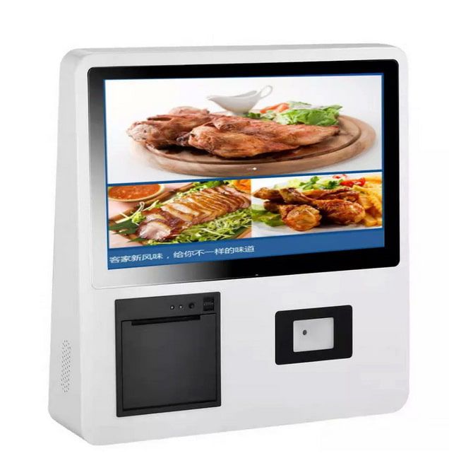 ตู้ Self Service Kiosk แบบติดผนังสีขาว หน้าจอสัมผัสแสดงผล Windows พร้อมช่องเสียบบัตร มุมมองเฉียงด้านหน้าสำหรับติดตั้งใช้งาน